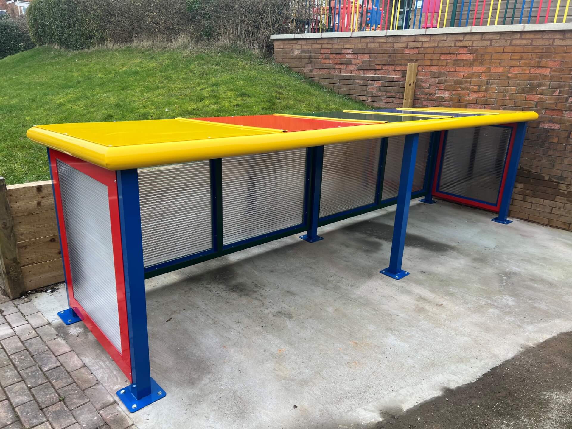 Buggy shelter with a yellow and red roof, blue frame and clear side panels