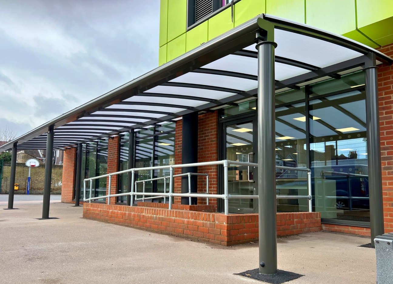Covered walkway with polycarbonate roofing providing dry pedestrian access