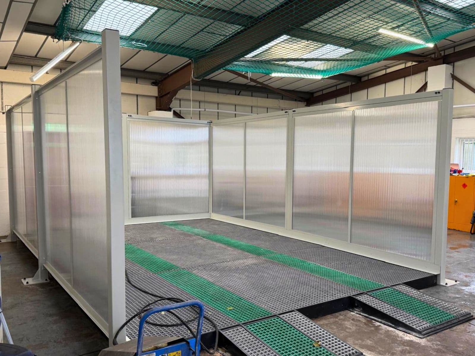 Clear polycarbonate jet wash screens around a three-sided wash bay